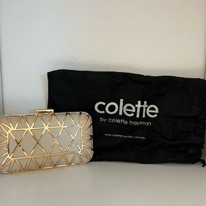 Colette gold and crème clutch